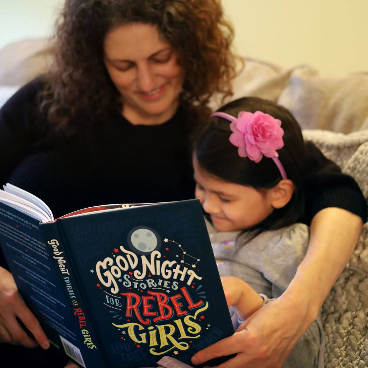 A Mom and a Daughter reading a book together